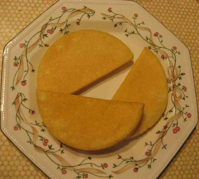A plate displaying three pieces of Bammies, cut in half-circle shapes