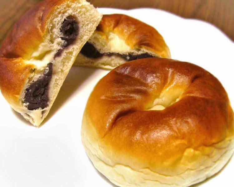 A plate of two Anpan, a traditional Japanese sweet bread filled with red bean paste