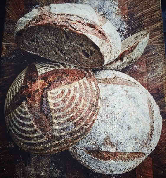High-angle close-up view of several loaves of artisan bread