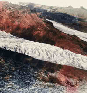 A glacier descending near Hof, with water cascading over the rugged mountain landscape