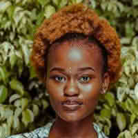 A woman named Olivia Ava with a stylish afro hairstyle, radiating confidence and charm